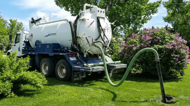 Professional vacuum truck performing residential drainage and septic maintenance in Erie, PA