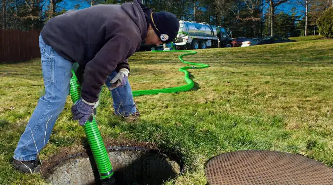 Service technician performing residential septic pumping and drainage maintenance in Erie, PA